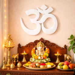 Om 3D printed wall decor placed inside a home temple with marigold flowers