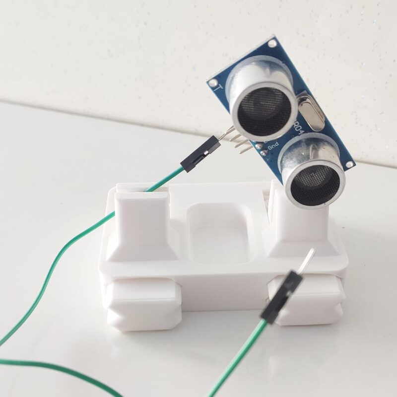 Close up of Anant PCB jig holding a green circuit board for precision soldering