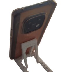 Portable phone stand folded completely flat next to a laptop for travel