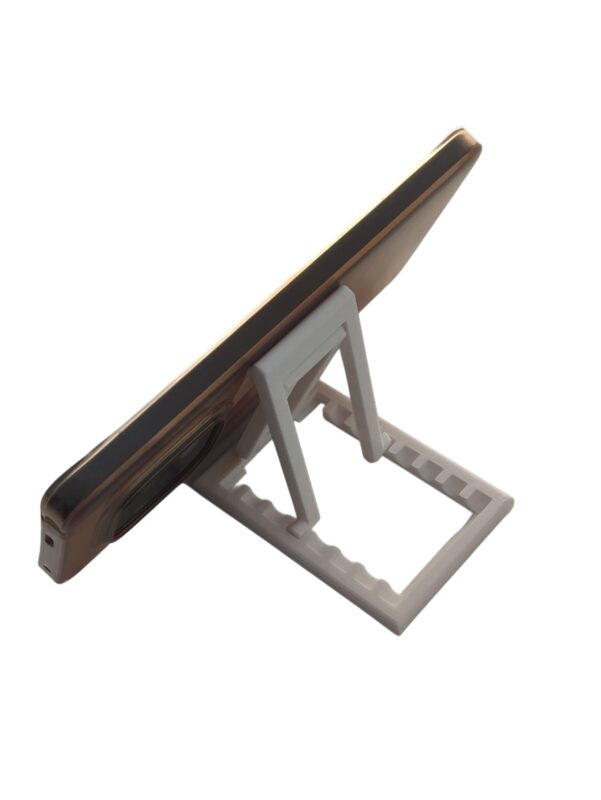 Portable phone stand folded completely flat next to a laptop for travel